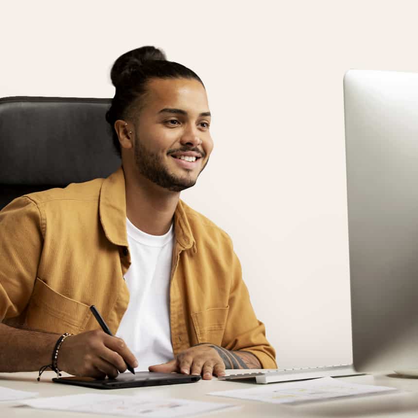 a man sitting at a table using a laptop