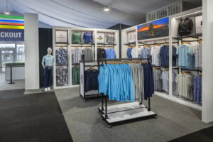 clothing racks in front of Indianapolis 500 branded wall displays