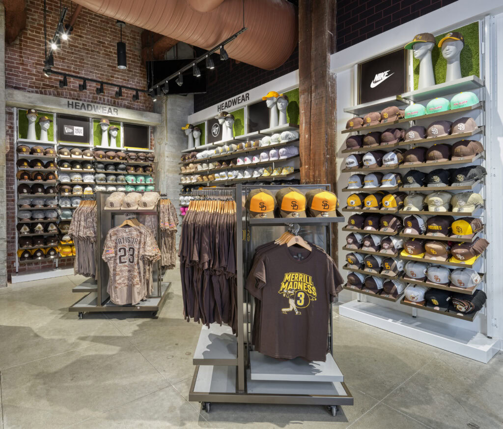shirt racks in front of wall hat displays