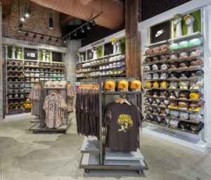shirt racks in front of wall hat displays