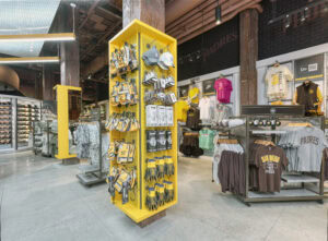tall yellow freestanding accessory gondola with Padres merchandise