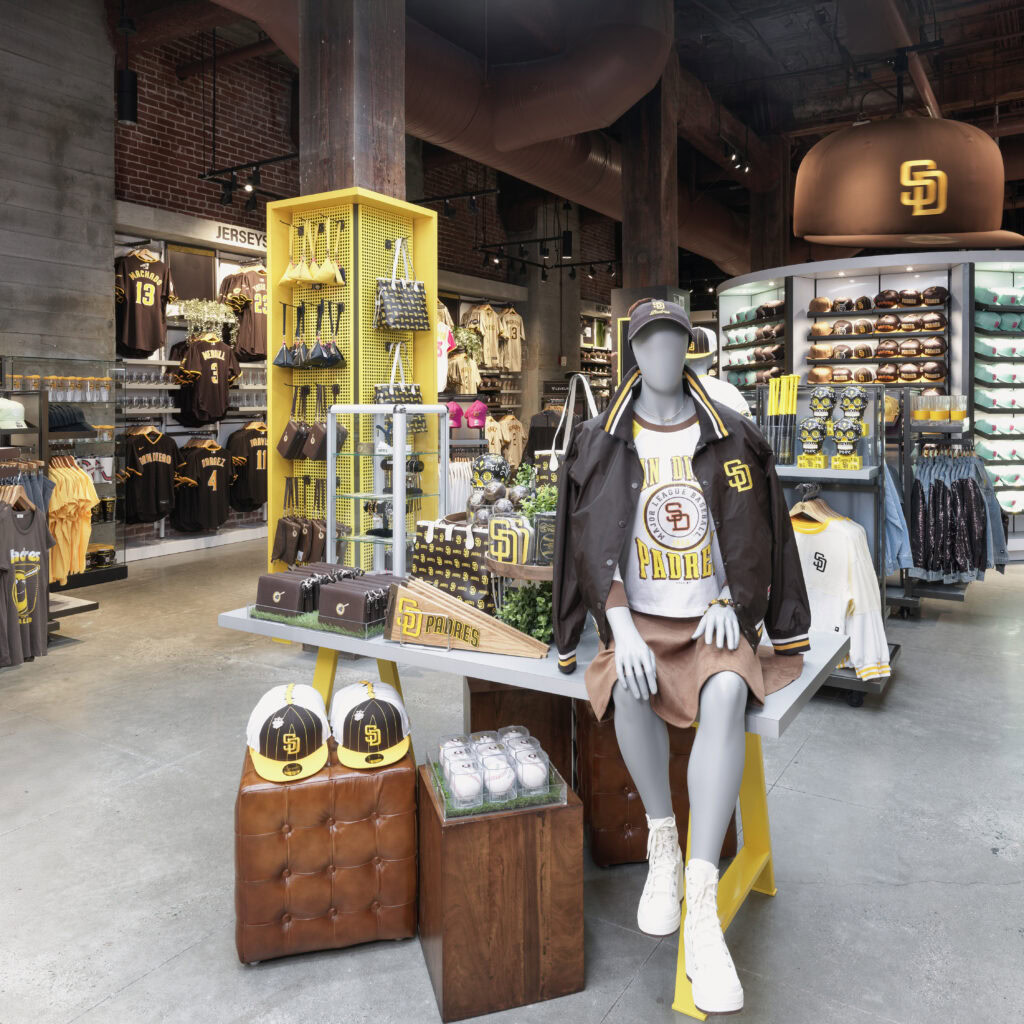 sitting mannequin on table of padres gear