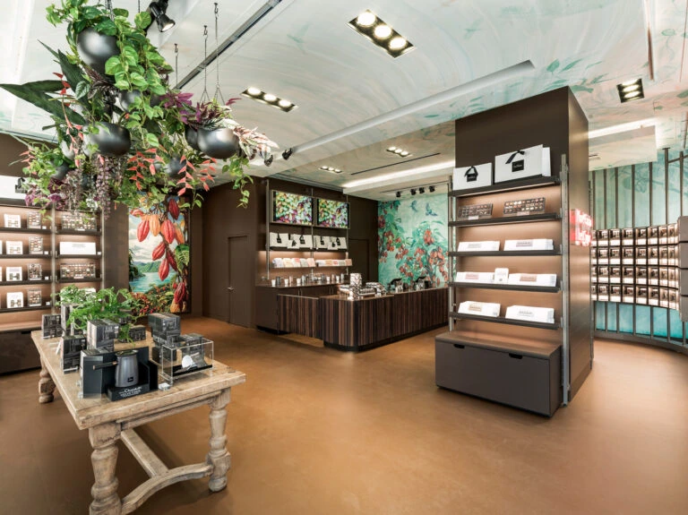 Overview image of Hotel Chocolat store with feature table and shelving