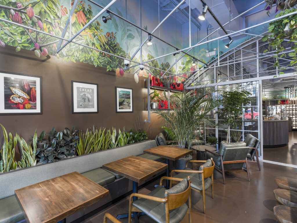 cafe seating with large nature mural on back wall