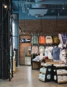 wall unit of womens shirt in front of brick wall