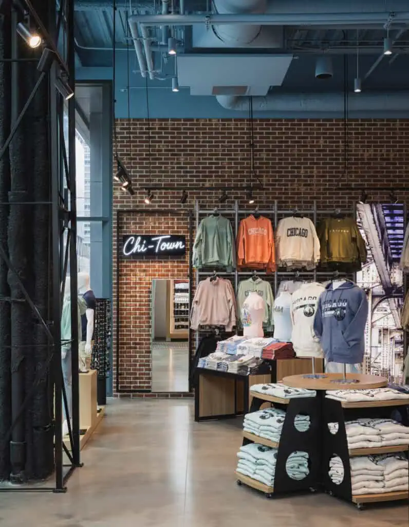 wall unit of womens shirt in front of brick wall